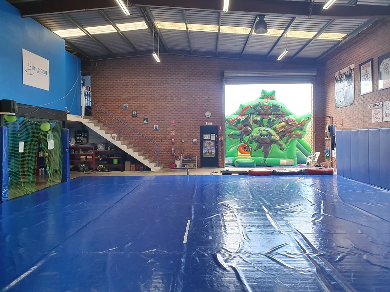 Our large wrestling mat ajoining a kids jumping castle